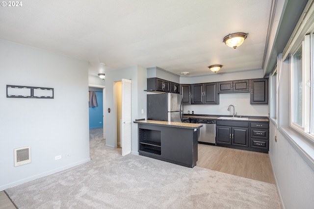 kitchen with dark brown cabinets, light colored carpet, stainless steel appliances, and sink