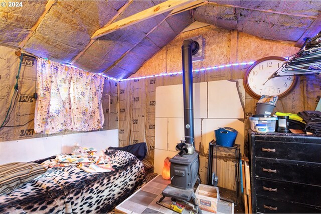 bedroom featuring a wood stove