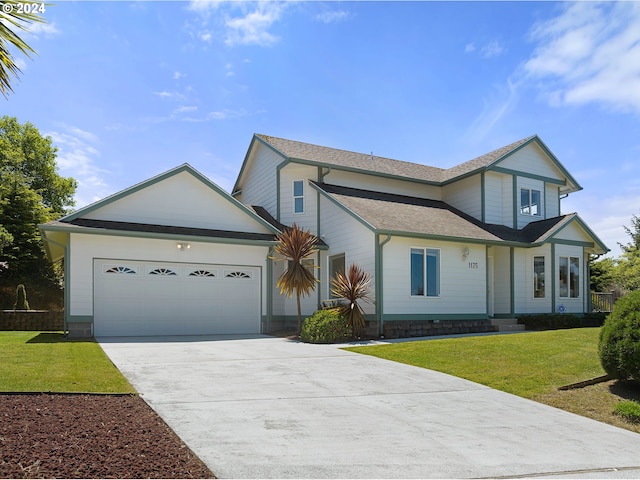 view of front of property with a front yard and a garage