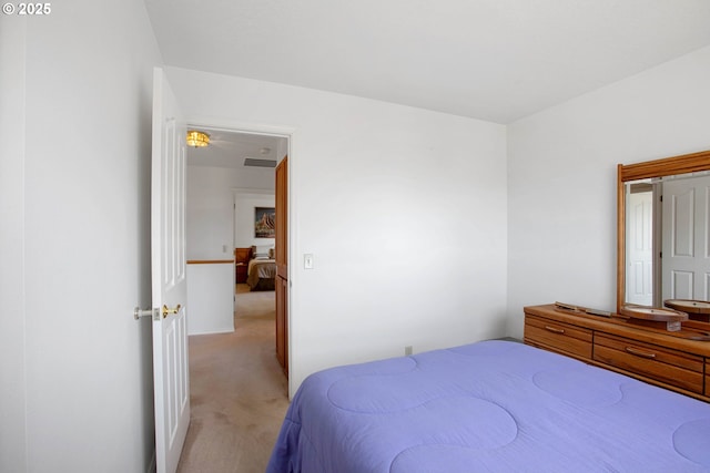 bedroom featuring light carpet