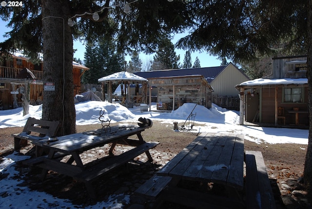 yard layered in snow featuring a patio area and a gazebo