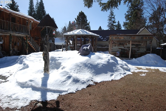 yard covered in snow featuring a gazebo