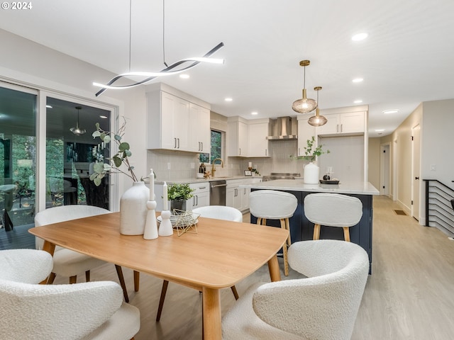 dining area with sink and light hardwood / wood-style flooring