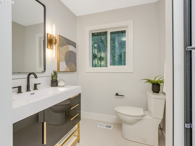 bathroom with toilet and vanity