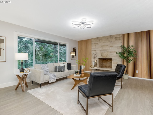 living room featuring wooden walls and light hardwood / wood-style flooring