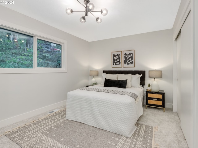 bedroom featuring a closet and light carpet