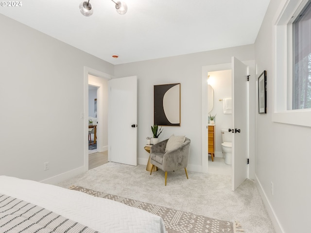 carpeted bedroom featuring connected bathroom