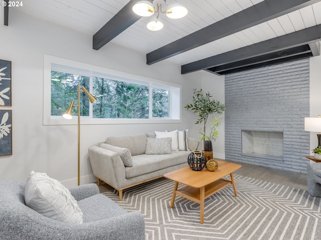 living room with beam ceiling, wood ceiling, and a brick fireplace