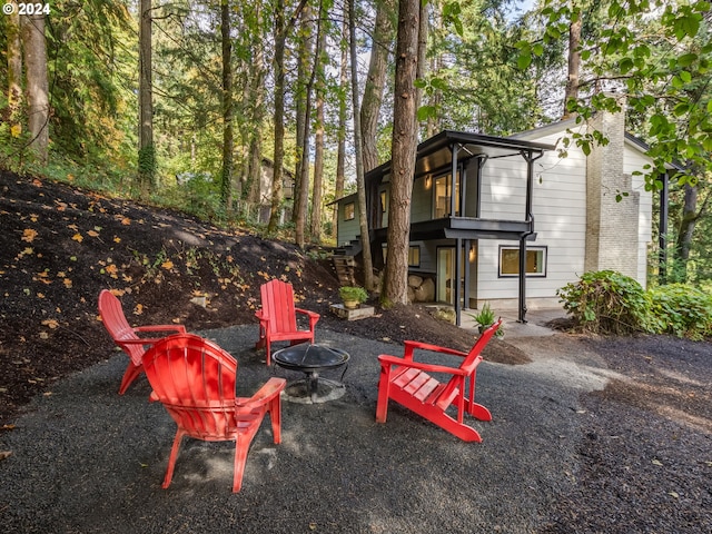 exterior space featuring an outdoor fire pit and a patio