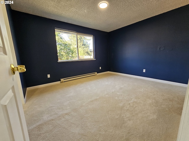 spare room featuring a textured ceiling, baseboard heating, and carpet floors