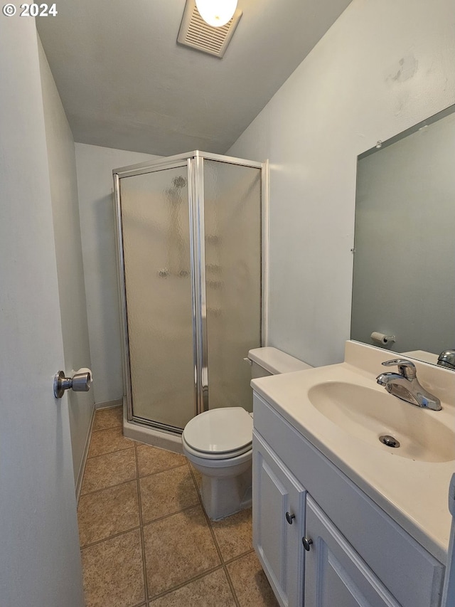 bathroom featuring vanity, tile patterned flooring, toilet, and an enclosed shower