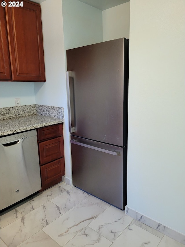 kitchen with stainless steel appliances and light stone counters