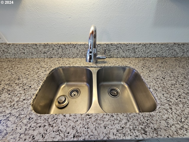 details with light stone countertops and sink