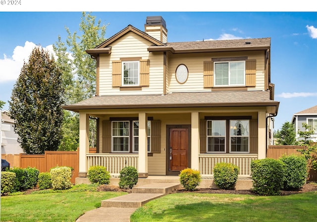 view of front of home with covered porch and a front yard