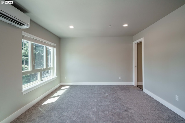 unfurnished bedroom featuring light colored carpet, a walk in closet, multiple windows, and a wall mounted AC