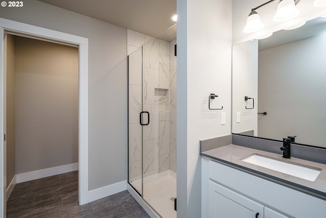 bathroom with dual bowl vanity, tile flooring, and a tile shower