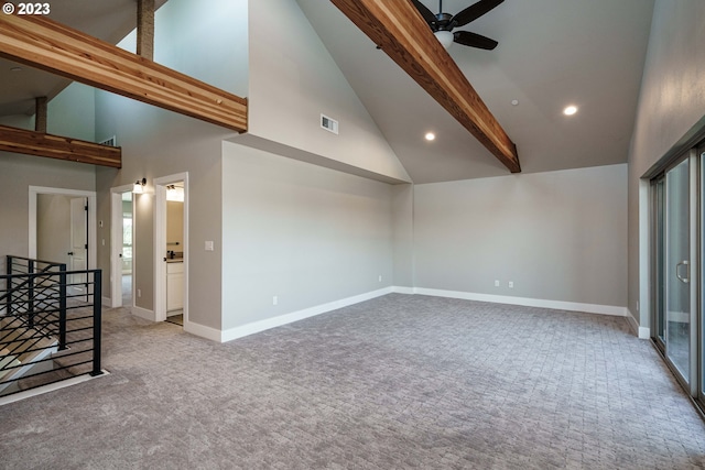 carpeted empty room featuring high vaulted ceiling, ceiling fan, and beamed ceiling