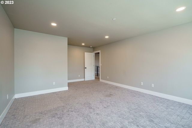 carpeted spare room featuring lofted ceiling with beams