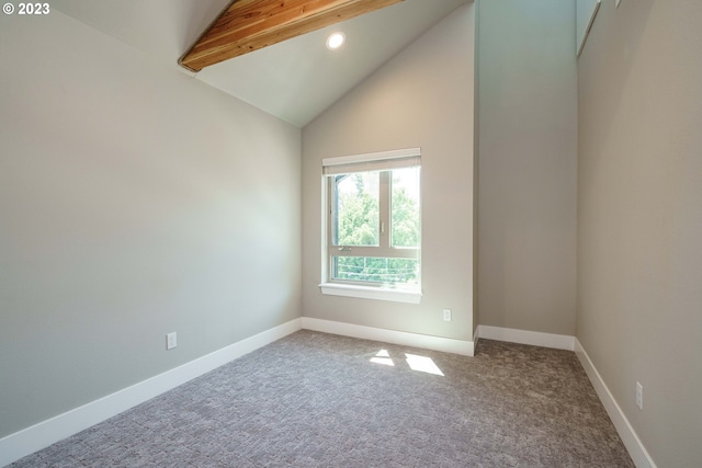 unfurnished bedroom with beamed ceiling, high vaulted ceiling, carpet, and a closet