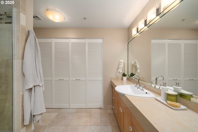 820 NW 12th Ave Unit 110, Portland, OR 97209 - full bath with vanity, visible vents, tile patterned flooring, and a closet