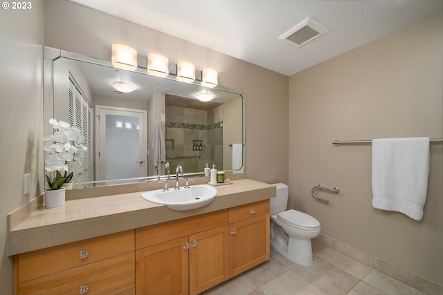 bathroom with tile patterned flooring, vanity, toilet, and a shower with door