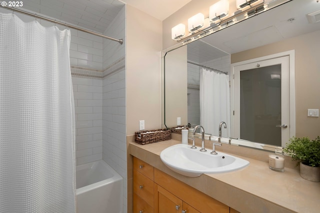 bathroom with shower / tub combo and vanity