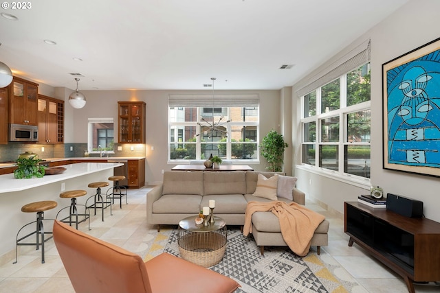 living room with light tile patterned floors and sink