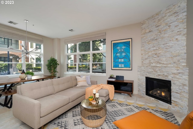 living room with light tile patterned flooring, plenty of natural light, and a fireplace