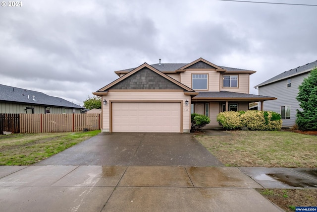 view of front of property featuring a front yard and a garage