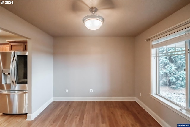 unfurnished room with light wood-type flooring and a wealth of natural light