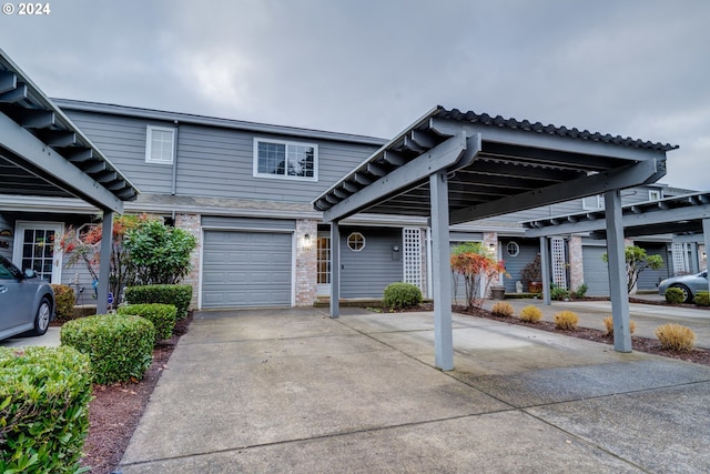 multi unit property featuring a garage and a carport