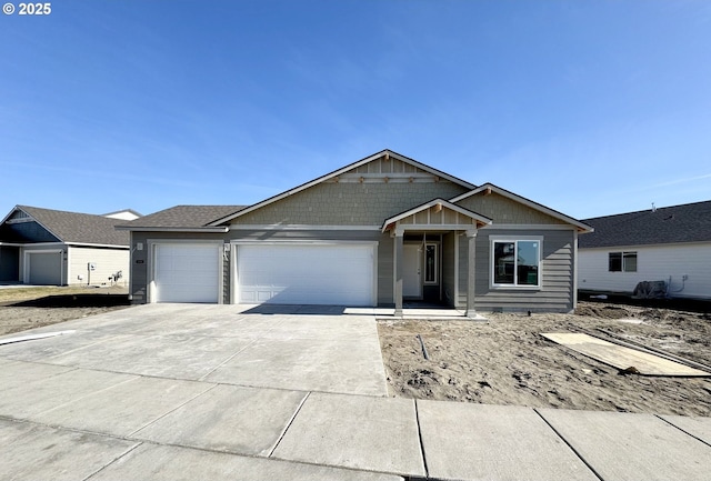 view of front of property featuring board and batten siding, driveway, and an attached garage