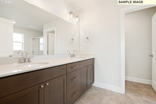 bathroom with vanity and an enclosed shower