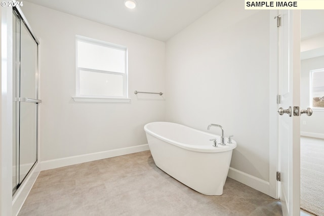 bathroom featuring separate shower and tub