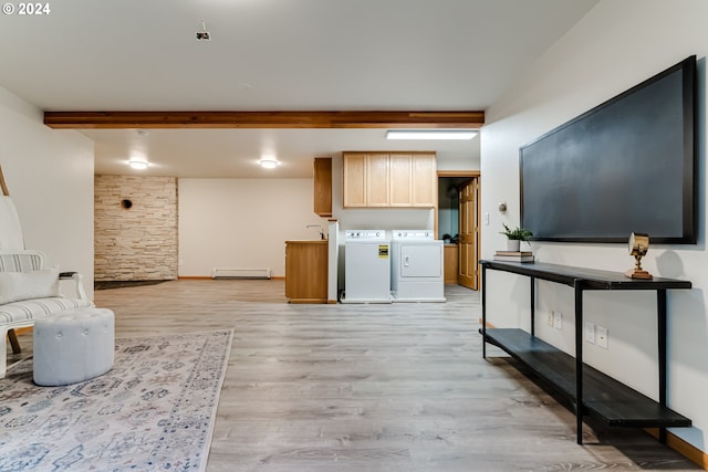 living room featuring light hardwood / wood-style floors, separate washer and dryer, beam ceiling, and baseboard heating