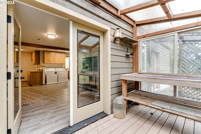 sunroom featuring separate washer and dryer and a skylight