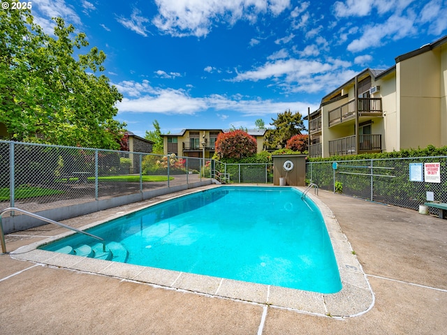 community pool with fence and a residential view
