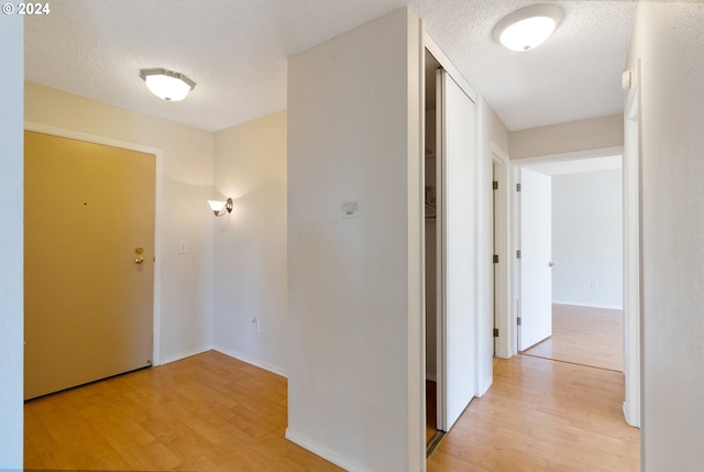 unfurnished bedroom with light hardwood / wood-style flooring, two closets, and a barn door