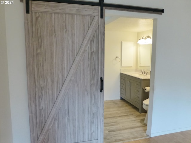 bathroom with vanity, toilet, and hardwood / wood-style flooring