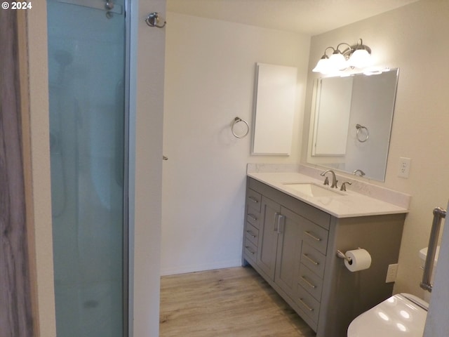 bathroom featuring an enclosed shower, hardwood / wood-style flooring, and vanity