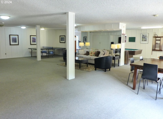 carpeted living room featuring a textured ceiling and a wealth of natural light