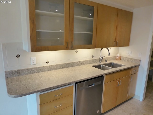 kitchen featuring light stone counters, a textured ceiling, stainless steel appliances, backsplash, and light brown cabinets