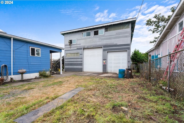 rear view of house with a garage