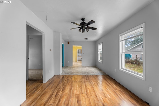 unfurnished room with light wood-type flooring and ceiling fan