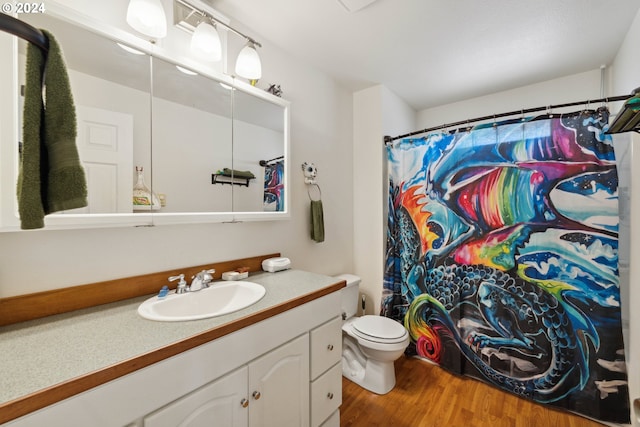 full bathroom featuring toilet, wood finished floors, vanity, and a shower with curtain