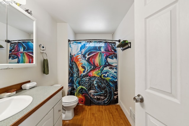 bathroom featuring visible vents, vanity, toilet, and wood finished floors