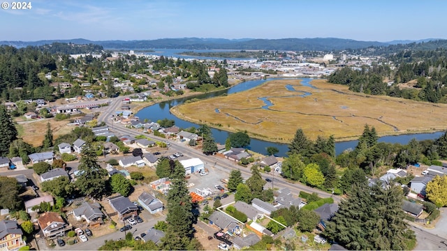 drone / aerial view featuring a water view and a residential view