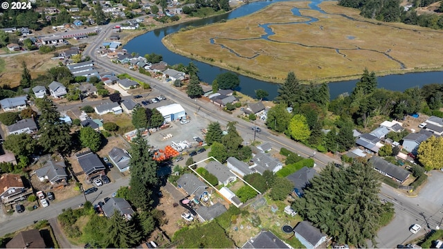 birds eye view of property with a water view and a residential view