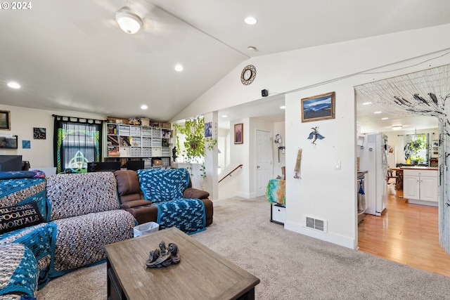 living area featuring recessed lighting, visible vents, light carpet, vaulted ceiling, and baseboards