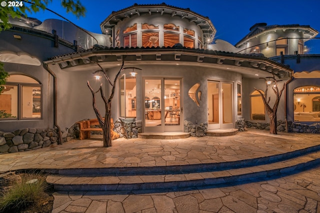 back house at twilight with a patio